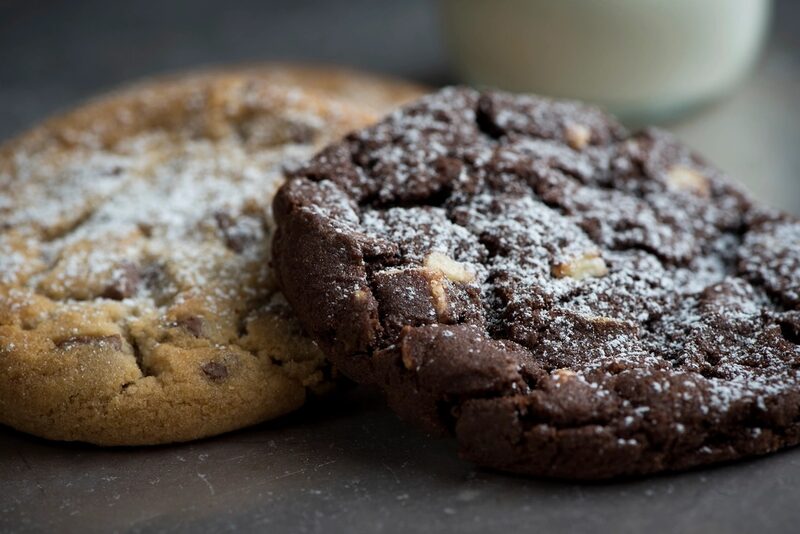 A golden cookie beside a dark chocolate cookie