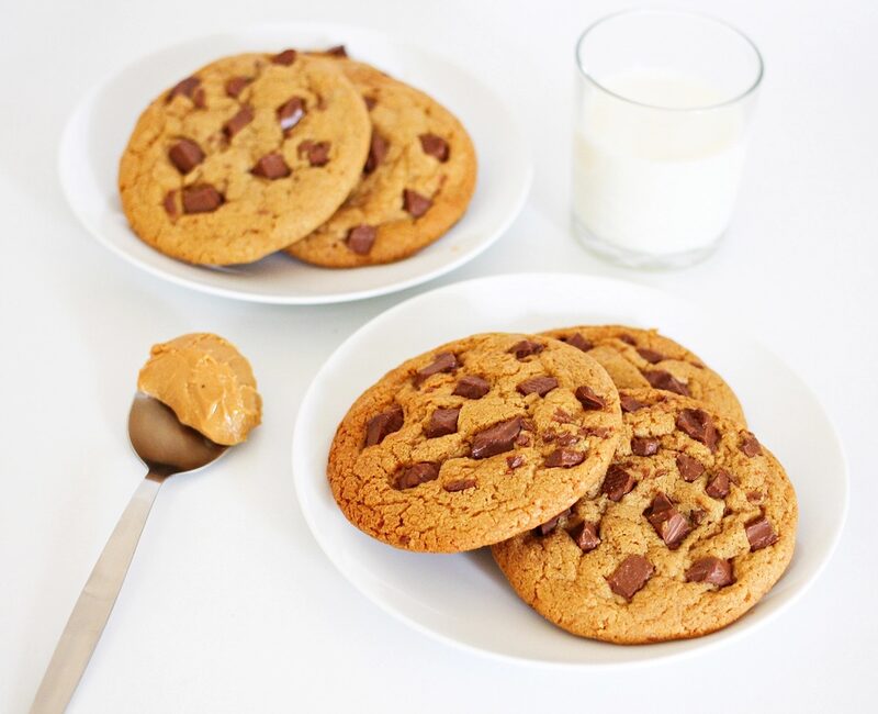 Chocolate chunk cookies with a glass of milk and a spoon of peanut butter