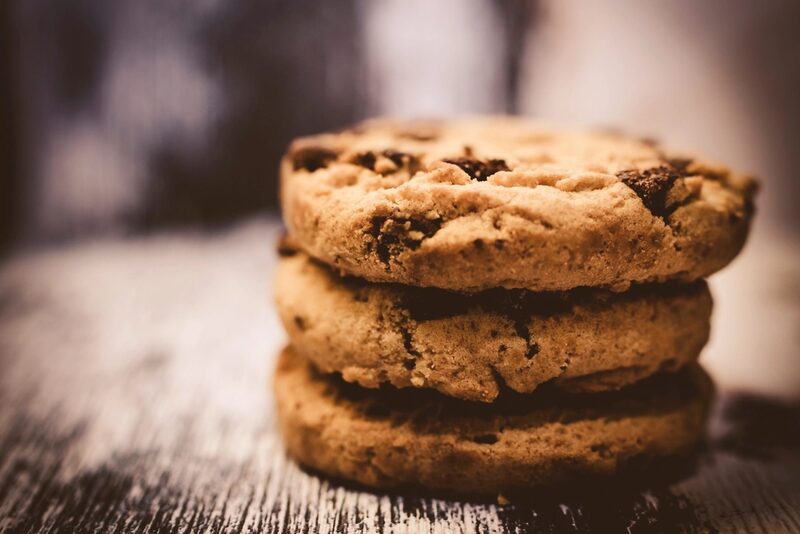 A stack of four golden chocolate chip cookies